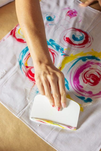 scraping shaving cream off dyed bandana