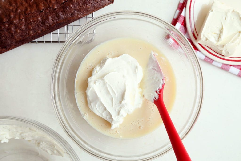 folding whipped cream into sweetened condensed milk.