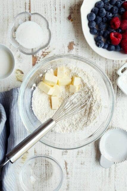 making crostata crust with flour and cold butter in a small bowl.
