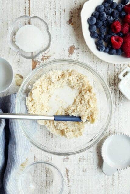 Adding buttermilk to pie crust.
