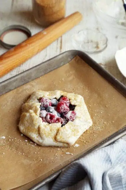 Unbaked crostata on parchment lined baking sheet