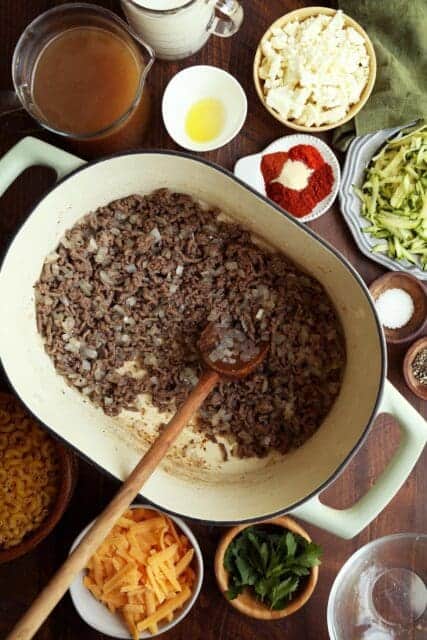 Ground beef and onions cooking in hot dutch oven.