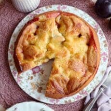 Baked plum cake recipe with slice taken out.