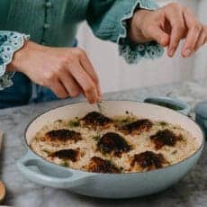 Tearing fresh dill over Nashville hot chicken recipe.