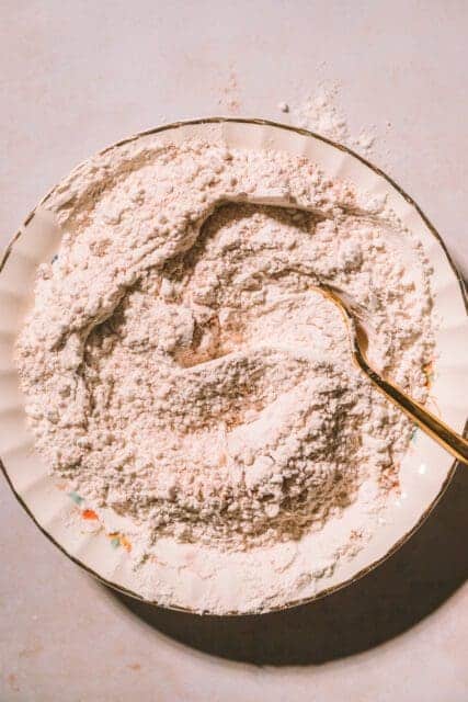 dry ingredients for pumpkin muffin recipe mixed in antique bowl.