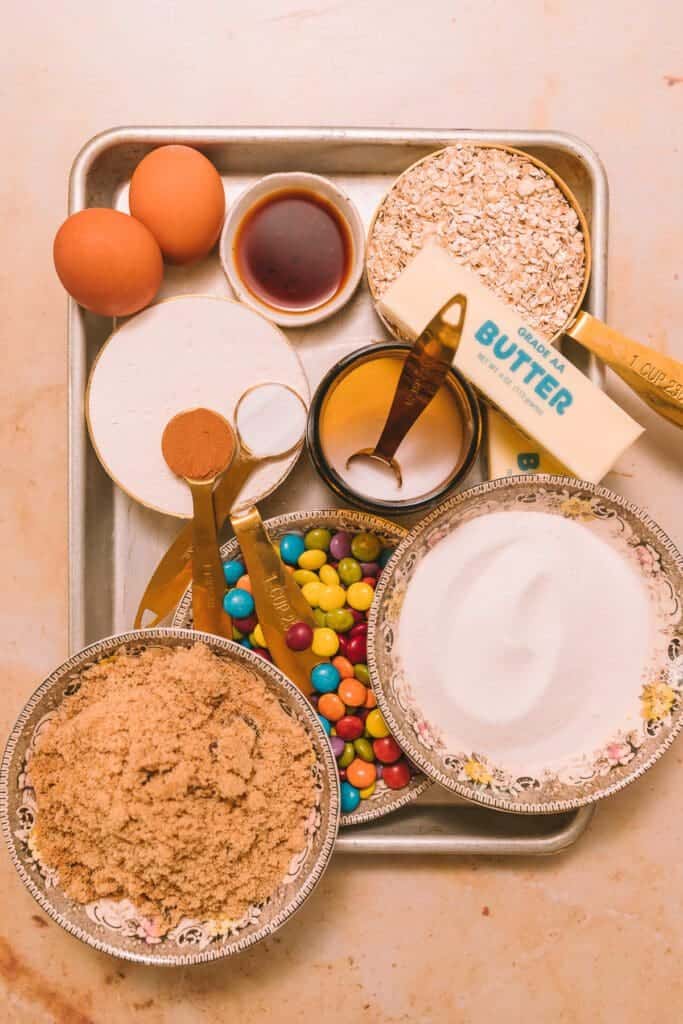 ingredients for Taylor Swift cookies in bowls on a baking sheet.