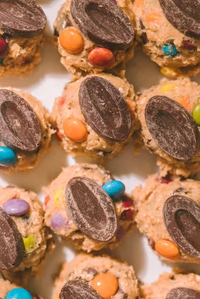 Taylor Swift cookie dough balls on baking sheet.