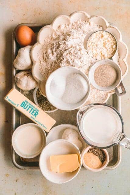 Ingredients for pull apart garlic bread on a sheet pan.