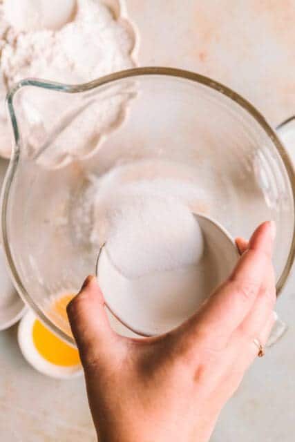 Adding sugar to pull apart garlic bread dough.