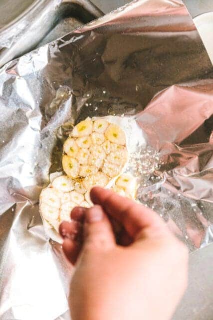 Whole garlic heads in foil to roast