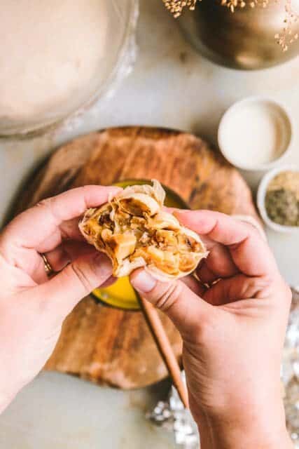 Squeezing a head of roasted garlic