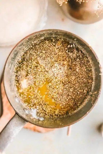 Roasted garlic and herb butter in a small saucepan.