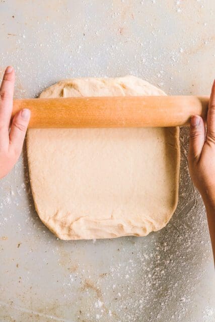 Rolling out dough with a wooden roller