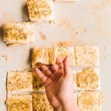 Stacking pull apart garlic bread squares.