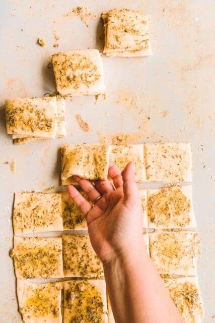 Stacking pull apart garlic bread squares.
