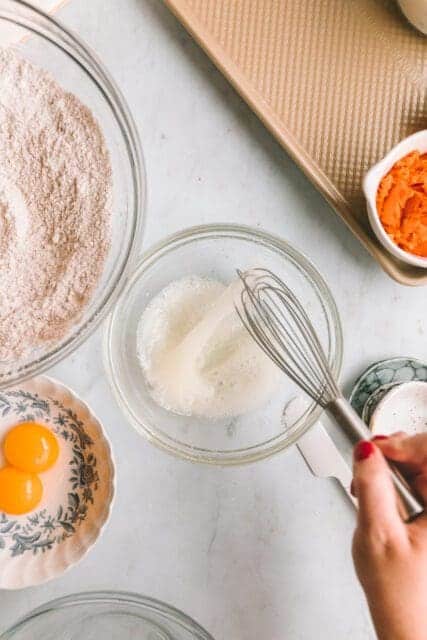 whisking egg white in small bowl.