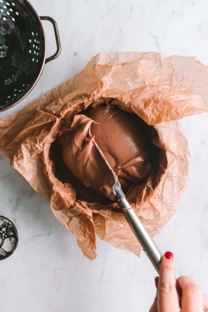 Chocolate basque cheesecake batter dolloped into pan.
