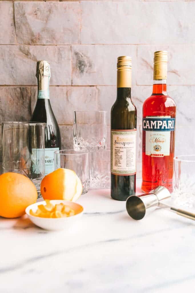 Bottles lined up to make a negroni sbagliato