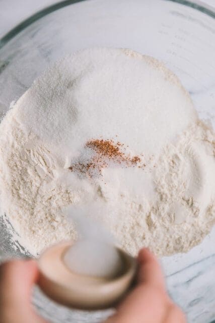 Adding dry ingredients to bowl