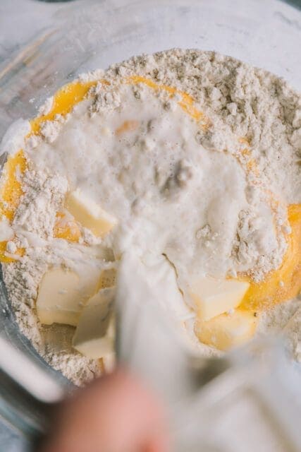 Adding milk to dough in medium bowl