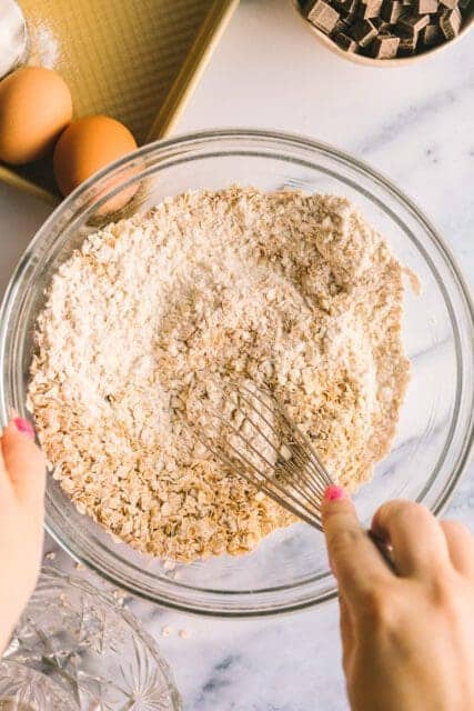 mixing dry ingredients for cookies using a metal whisk.