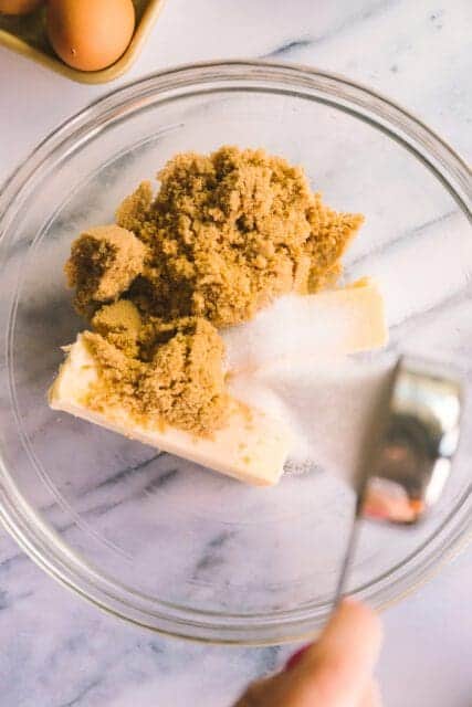 measuring sugar in a bowl for cowboy cookie recipe