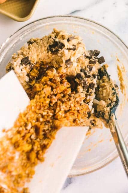 adding cereal brittle into cookie dough for cowboy cookies.