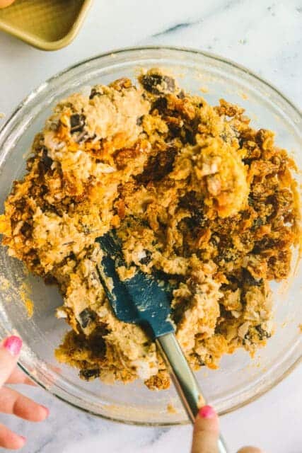 uncooked cookie dough in a bowl with a spatula.