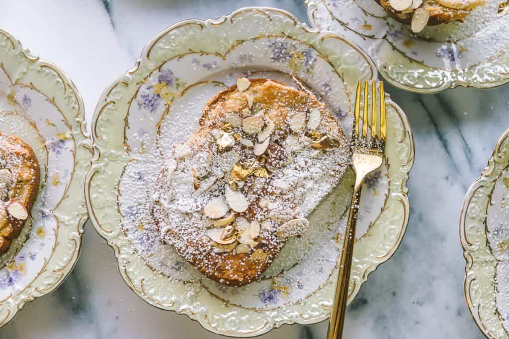 Mardi Gras dessert or easy bostock recipe on a vintage plate with a vintage fork.