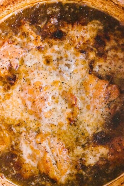 close up shot of melted cheese over French onion chicken