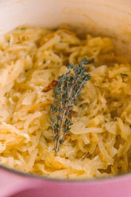 thyme added to onions caramelizing for chicken recipe