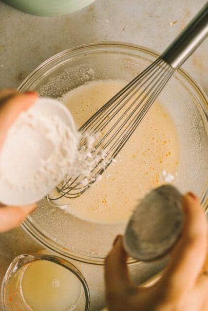 whisking confectioners sugar together for lemon bar filling