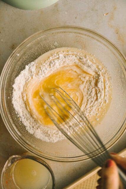 whisking ingredients together in a glass bowl