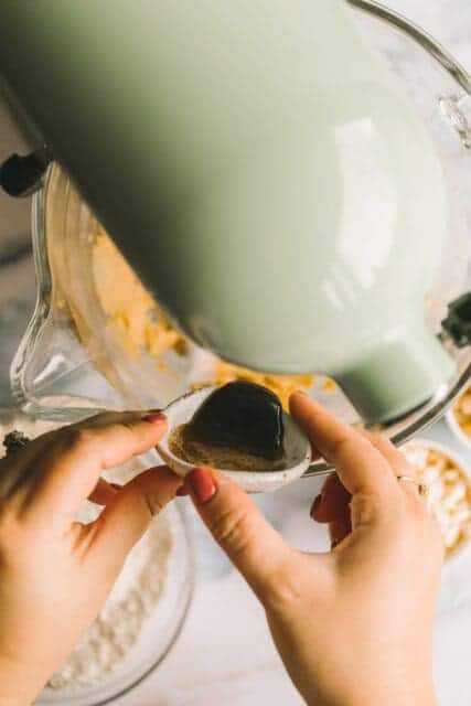 mixing in vanilla bean paste into white chocolate macadamia nut cookie recipe
