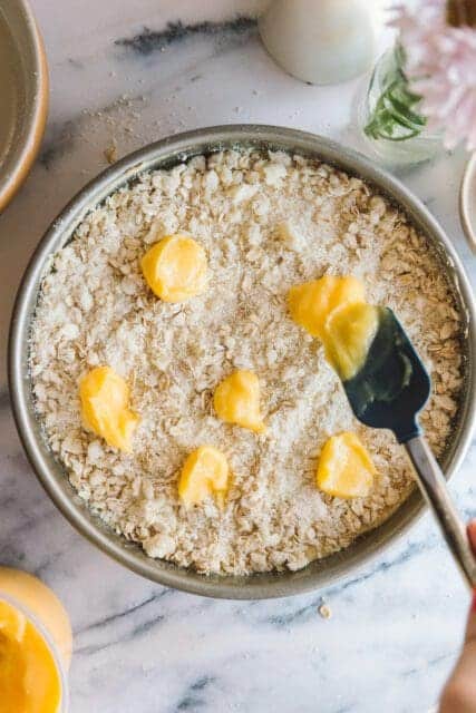 dollops of lemon curd on top of lemon cake batter