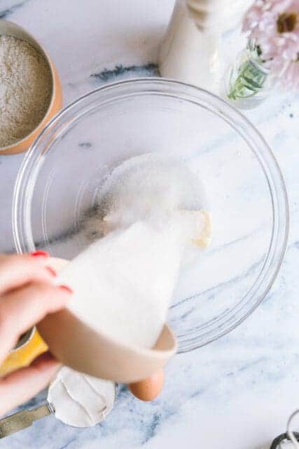 pouring sugar into a mixing bowl