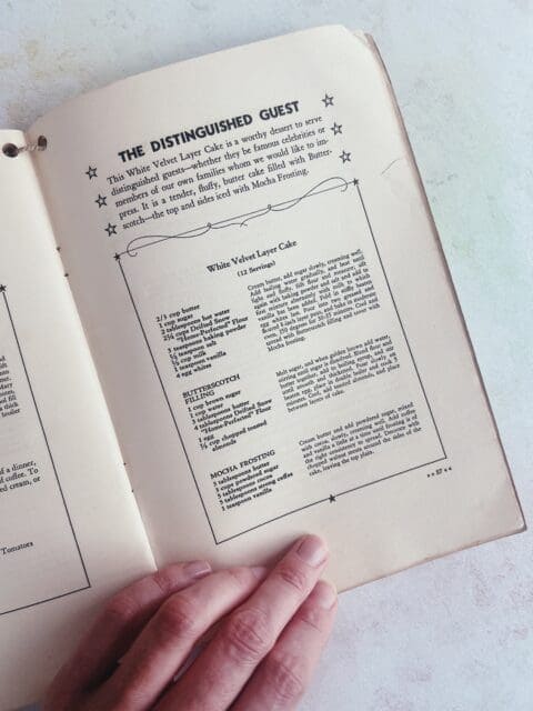 a recipe book full of vintage birthday cakes