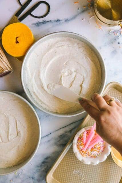 leveling batter with an offset spatula for a layered vintage birthday cake