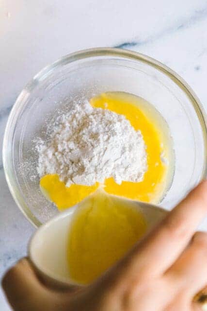 combining powdered sugar and butter to make frosting