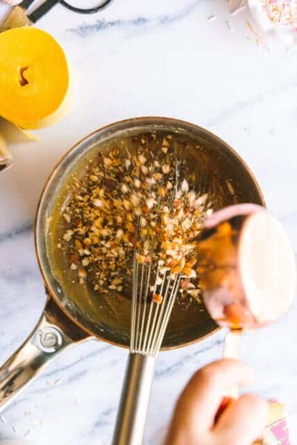 adding chopped nuts to a saucepan for a birthday cake recipes