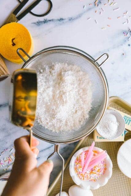 sifting flour to make a birthday cake