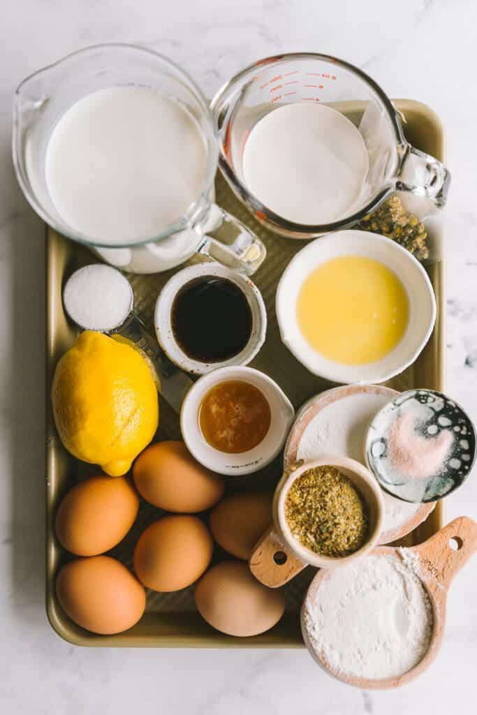 ingredients for a crêpe cake recipe on a gold baking pan