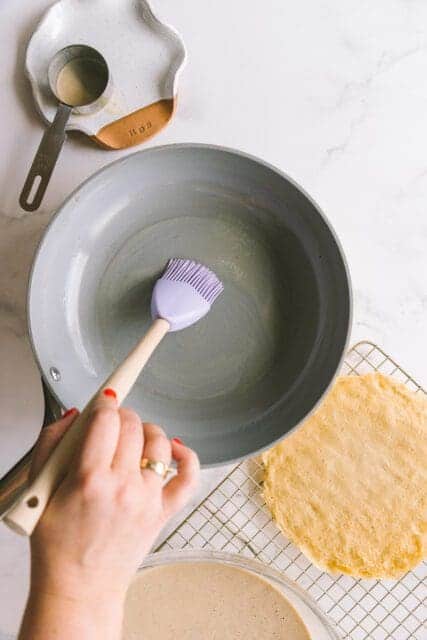 brushing non-stick-frying pan with melted butter