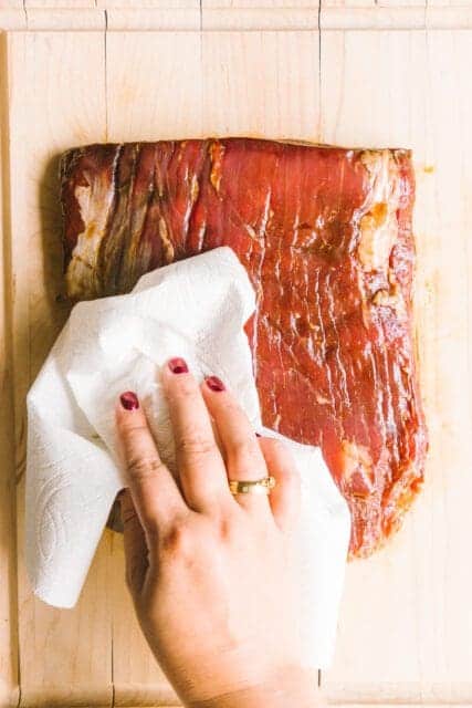 patting the flank steak dry to cook