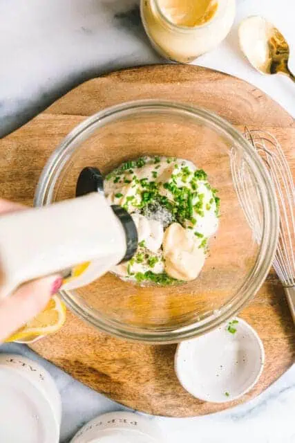 adding spices and herbs to make a horseradish mayo as a topping for the French dip sandwich