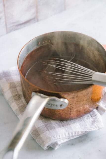 whisking hot melted chocolate to make pudding
