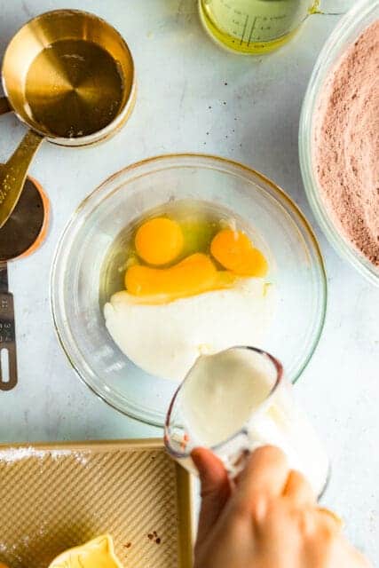 In a separate bowl whisk together the wet ingredients:  whole eggs and an egg white, and buttermilk.