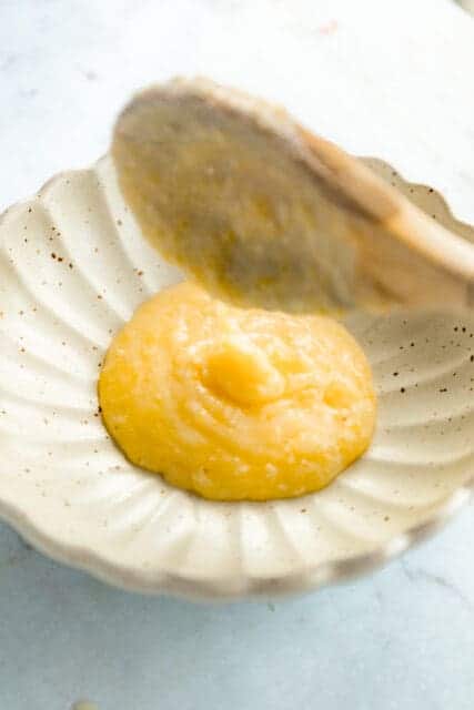 serving baked polenta in a vintage dish