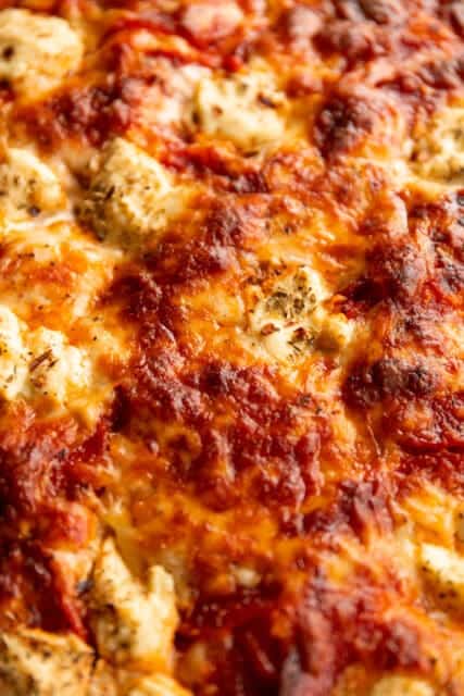 close up of focaccia pizza, in all its crusty glory