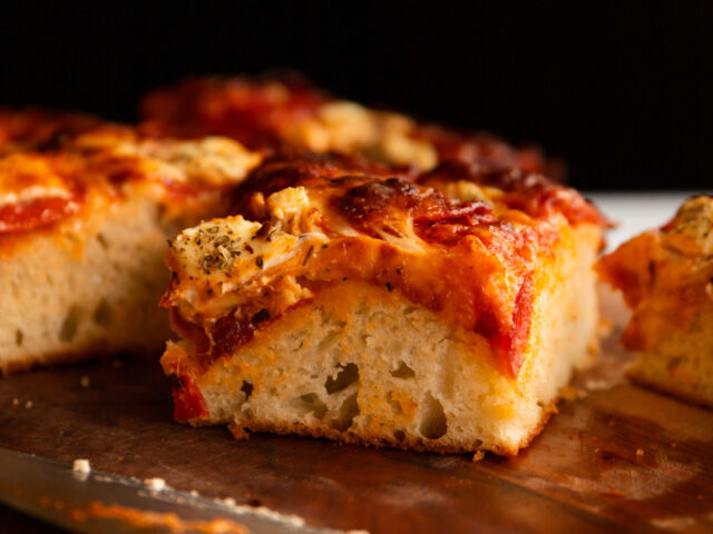 a straightforward angle of a slice of doughy, bready pizza